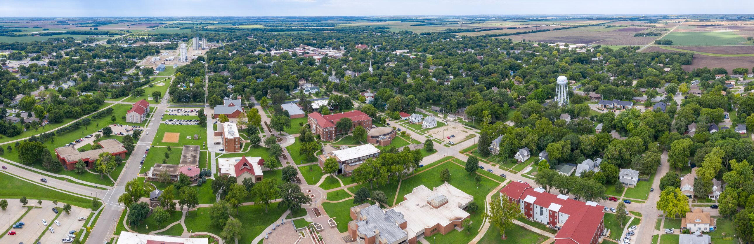lindsborg-kansas-aerial-town-view Aerial view of Lindsborg, Kansas showing downtown streets, tree canopy, and surrounding neighborhoods.