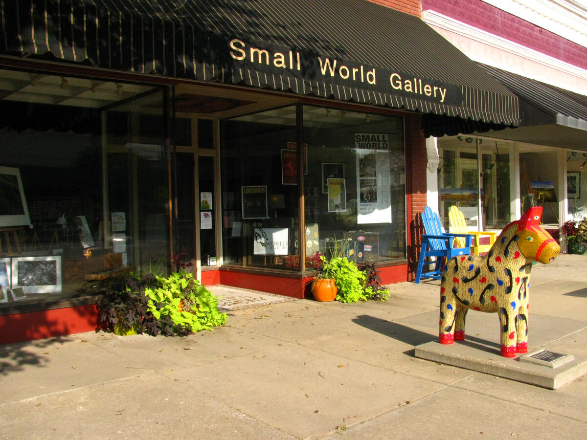 lindsborg-kansas-small-world-gallery-storefront The Small World Gallery storefront in Lindsborg with a painted Dala horse sculpture outside the entrance.