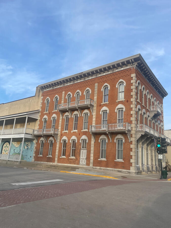 Brick museum building with arched windows and decorative trim at Vesterheim in Decorah.