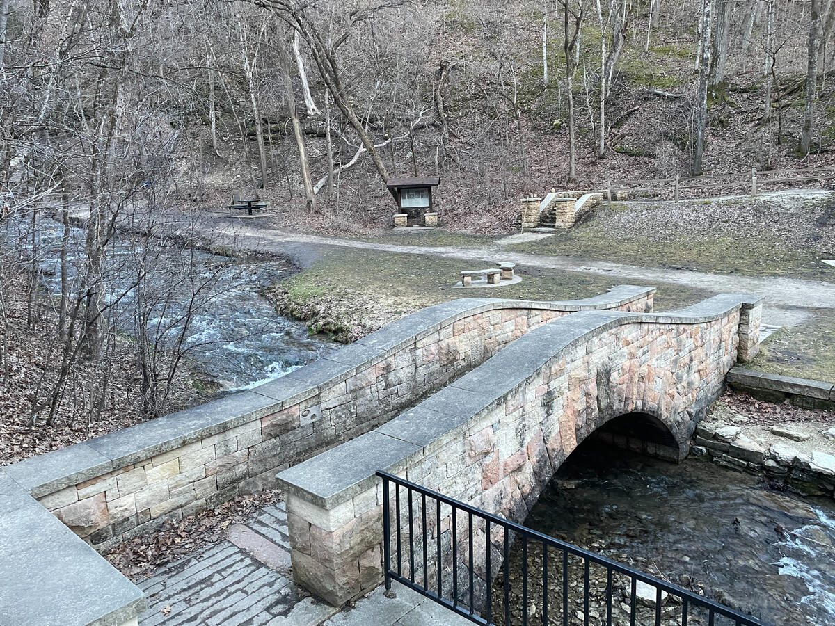 Stone footbridge crossing a shallow creek near Dunning’s Spring in Decorah.