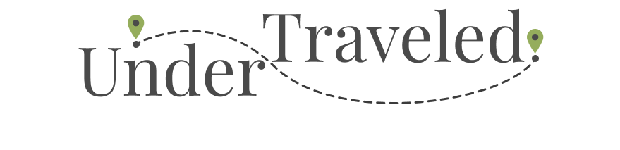 Logo UnderTraveled logo: stylized text ‘UnderTraveled’ with green map pins marking the start and end of a dotted travel path