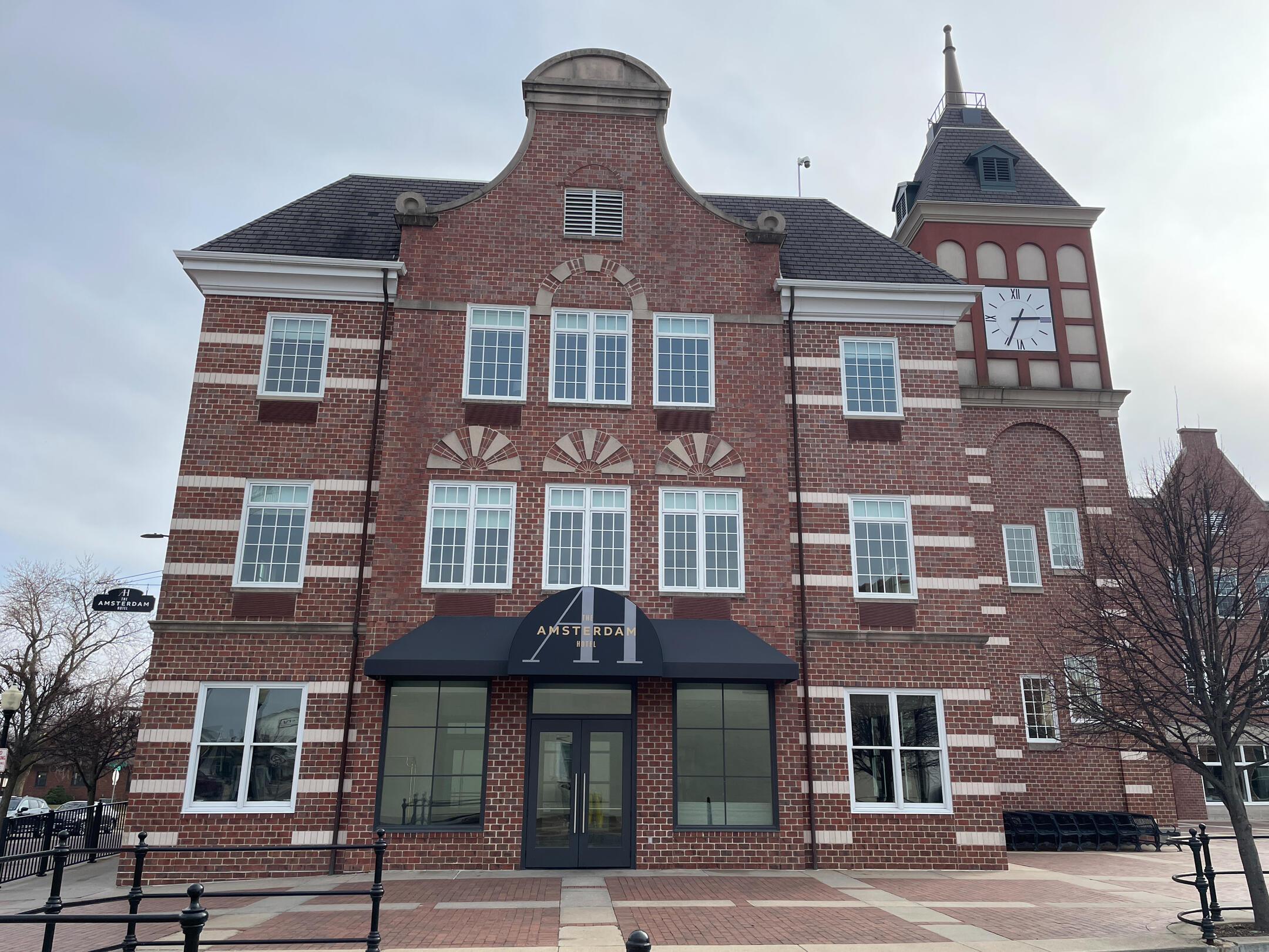 Exterior of the Royal Amsterdam Hotel with Dutch‑inspired brick architecture and a clock tower.