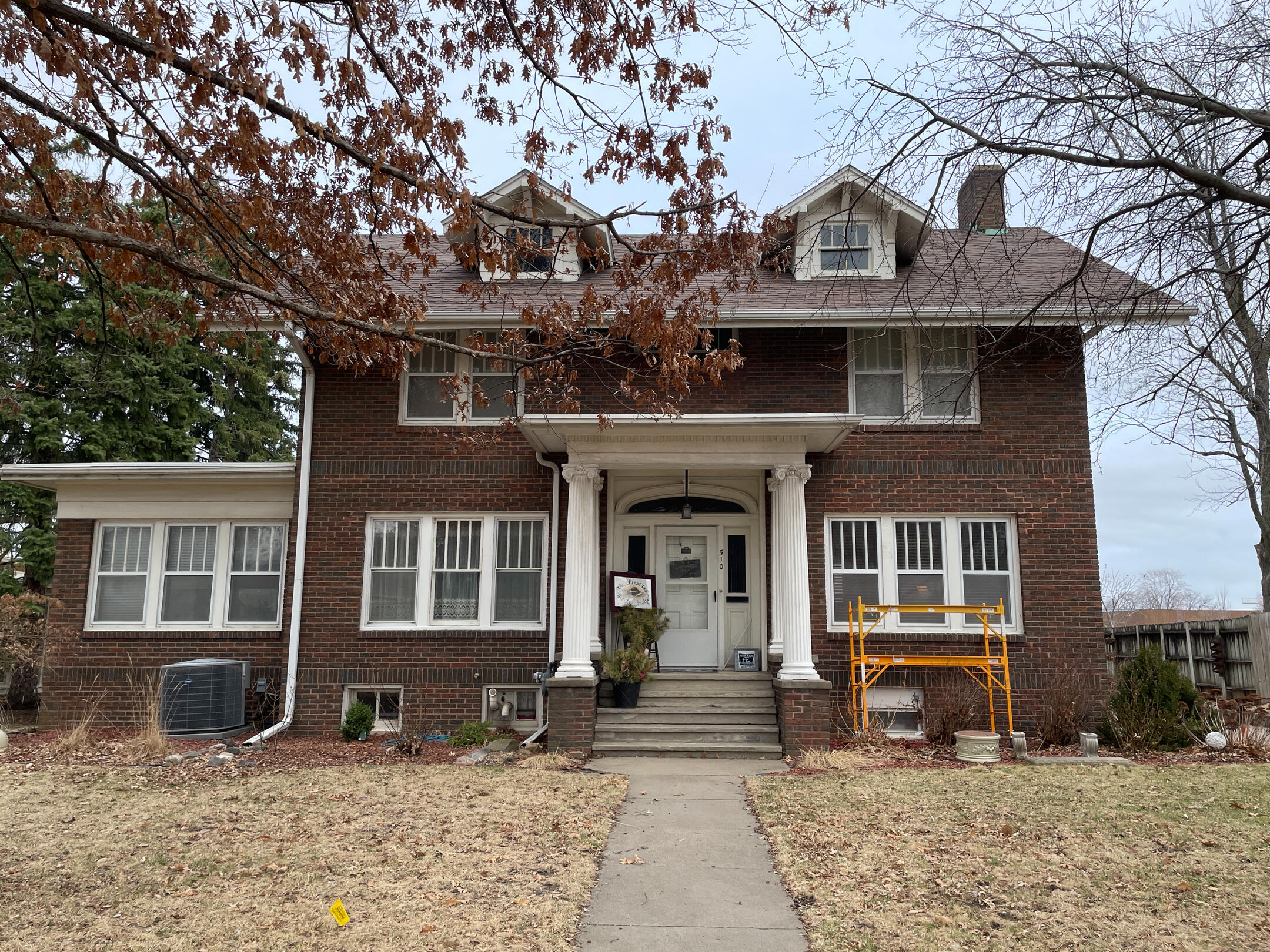 Two‑story brick Parsonage Bed and Breakfast with white trim and a columned front entry.