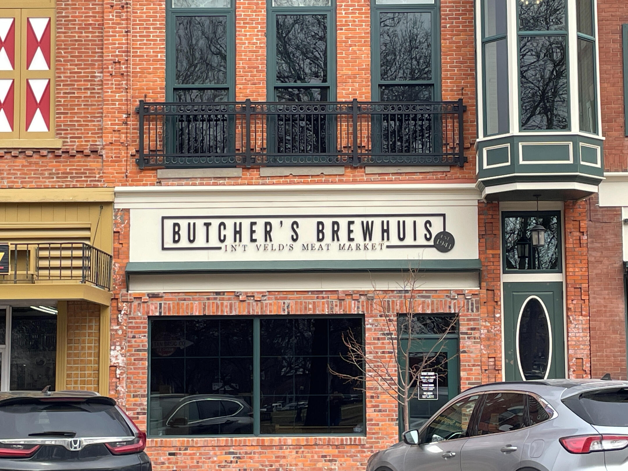 Exterior of Butcher’s Brewhuis and The Asylum bar on a brick downtown block in Pella.